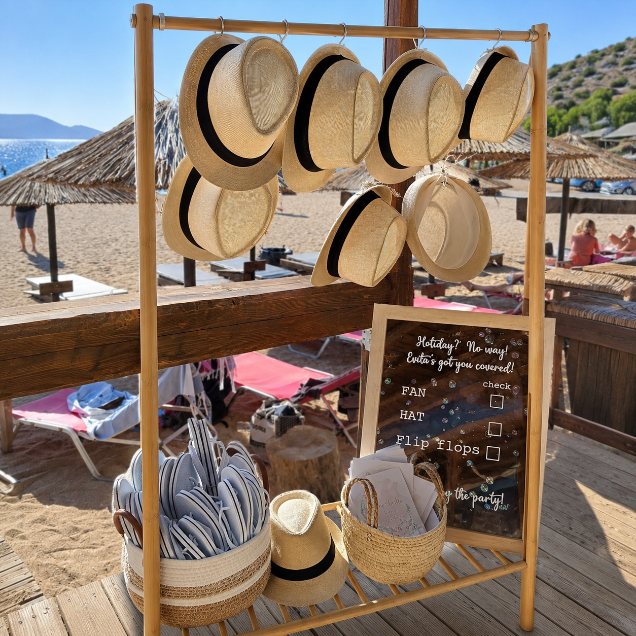 Boho beach wedding decoration at sunset with wooden aisle, floral arches and lanterns in Athens, Greece.